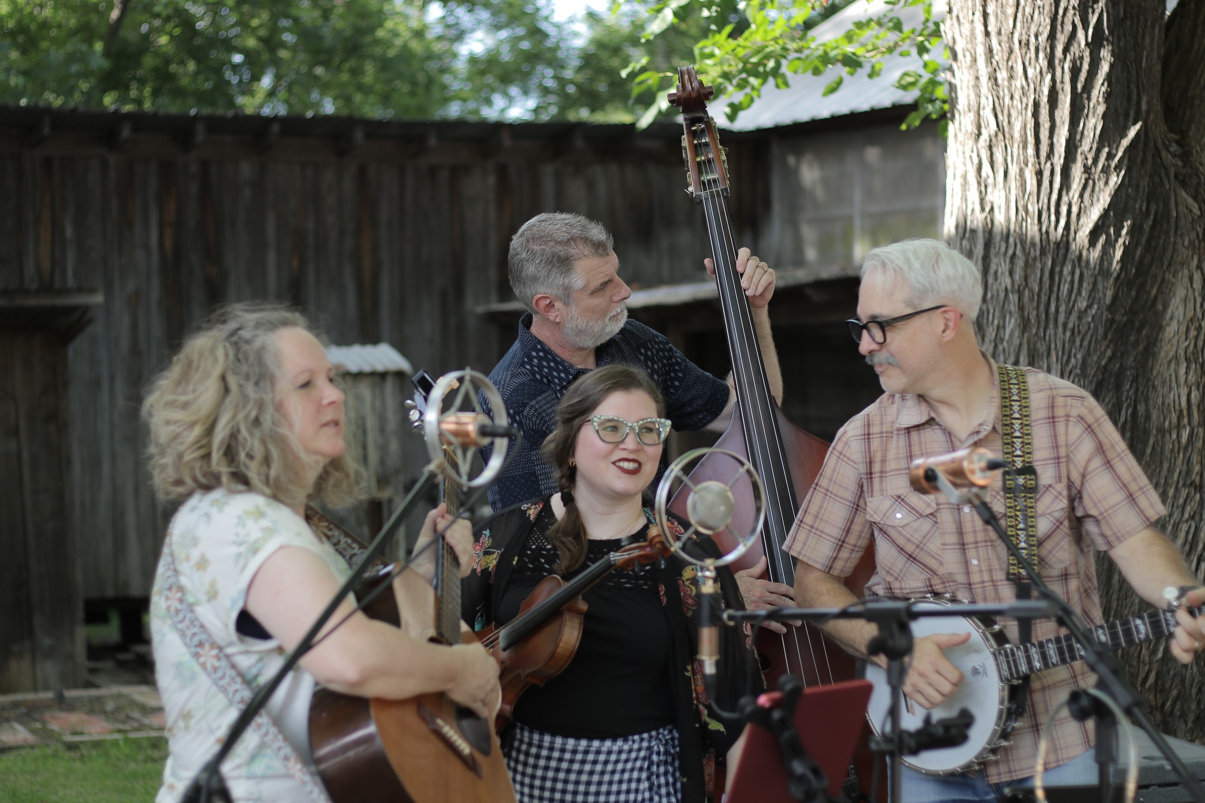 The Scrips performing around microphones at Edom Art Walk in 2026