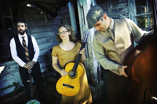 Three members of The Scrips outdoors with guitar and upright bass